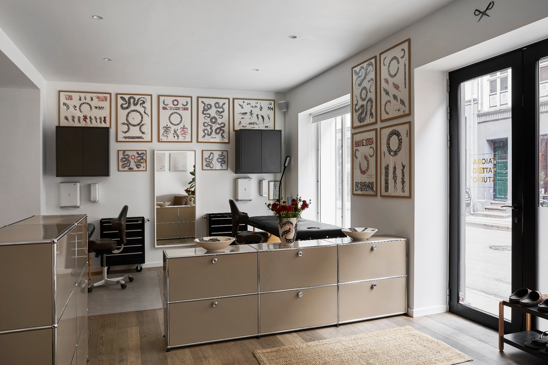 Taioba Tattoo Studio interior — workstation and framed calligraphy