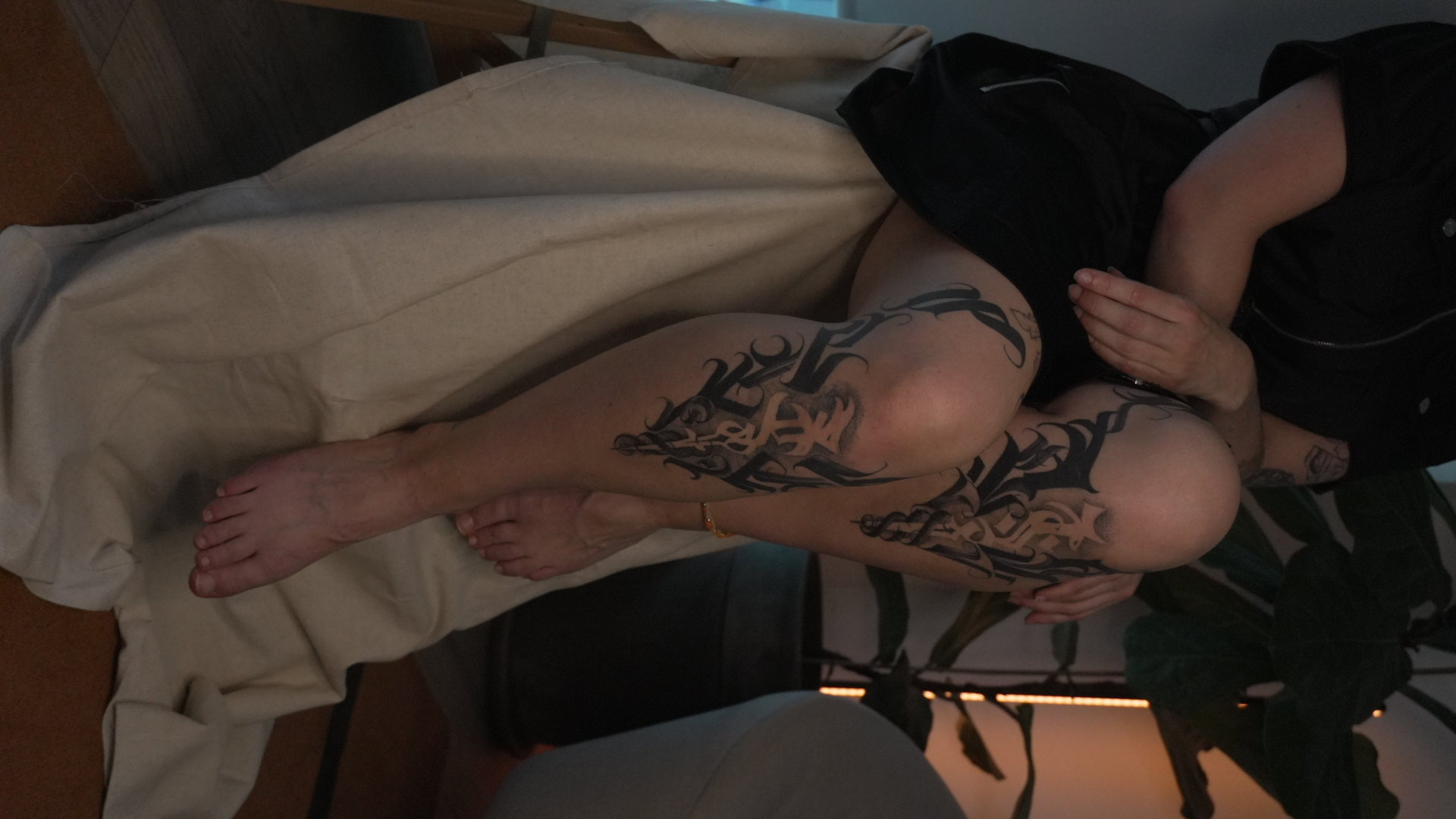 Lettering tattoo on legs