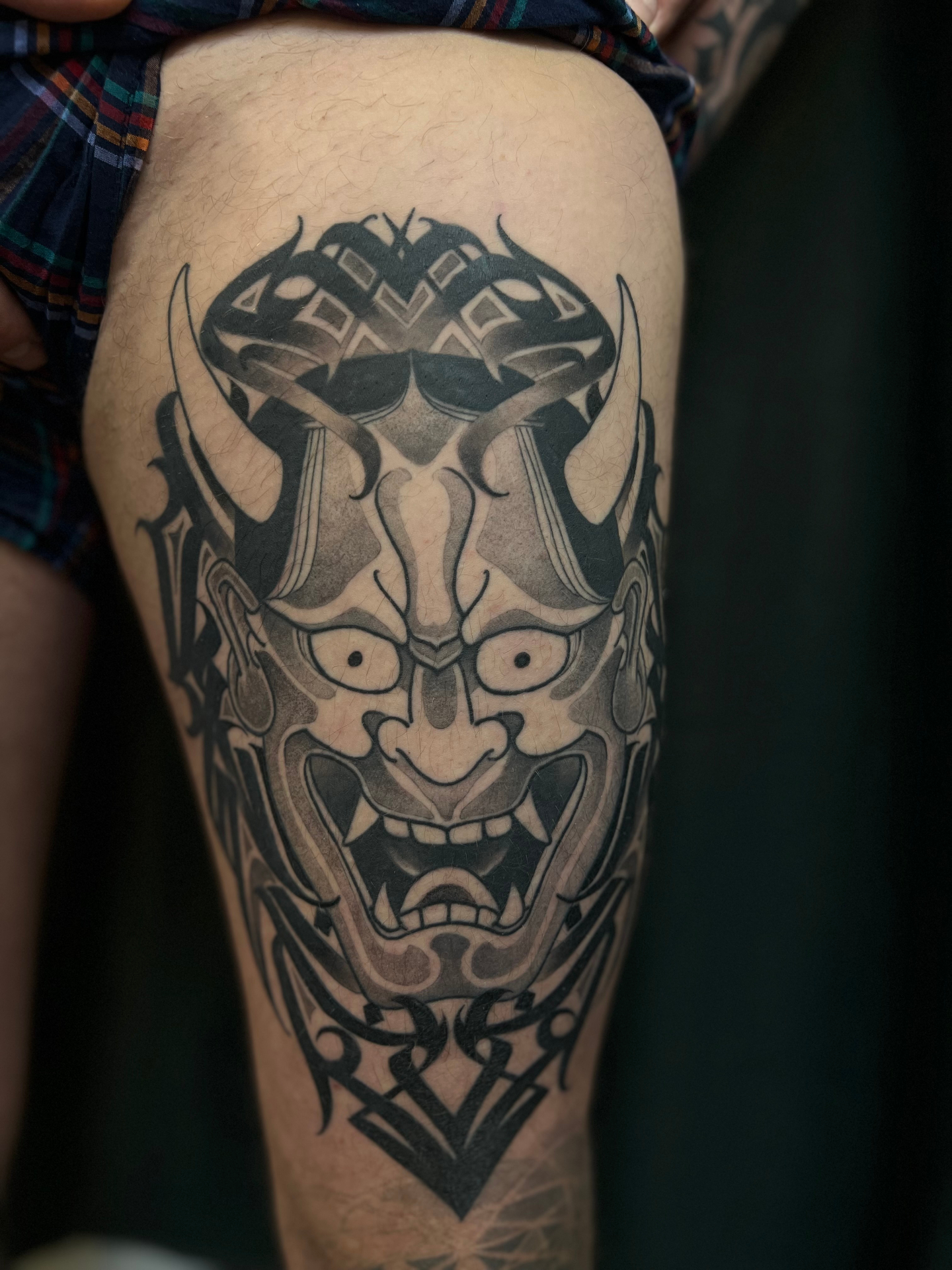 Hannya mask thigh tattoo